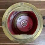 Top-down view of interior socket inside red fresnel post light