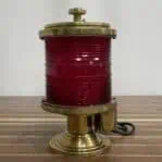 Rear angle of brass marine light with red lens and knob