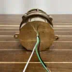 Back view of vintage brass light fixture showing rewired setup