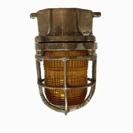 Front view of brass nautical ceiling light with orange glass lens