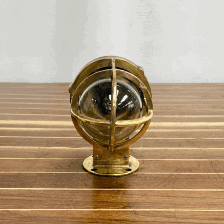 Indoor or Outdoor Brass Wall Sconce (4) view of brass cage and glass globe with natural wear