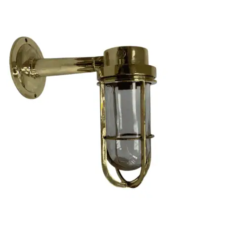 Side view of brass wall sconce with clear glass globe