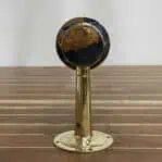 Back of brass wall sconce showing mounting plate and arm