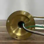 Close-up of brass sconce wiring and mounting base