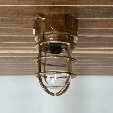 Short Cage Red Brass Ceiling Light Mounted brass ceiling light on wood panel