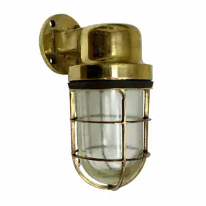 Vintage marine wall sconce with thick brass base mounted on wall