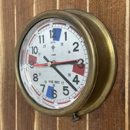 Vintage Polaris Brass Ship Clock (Non-Working) 03 Side view of vintage Polaris brass ship clock mounted on wood paneling