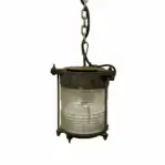 Vintage brass and steel ship lantern shown hanging by chain