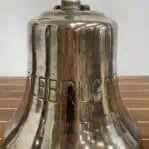 Close-up of Zeebrugge lettering on brass ship bell