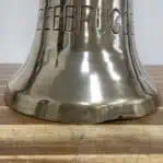 Brass ship bell with damaged bottom edge detail