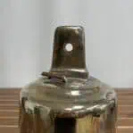 Top bracket detail with patina and bolt hole