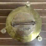 Top view of brass Perko Fresnel light showing PERKO stamp