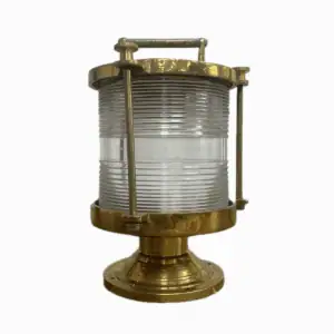Brass Perko Fresnel light with tall ribbed glass lens and brass base