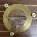 Top view of brass Perko Fresnel light showing PERKO-stamped lid