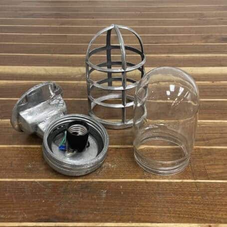 Vintage Aluminum Nautical Bulkhead Light - Salvaged Ship Fixture Disassembled vintage aluminum nautical bulkhead light showing cage, glass, and socket