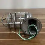 Wiring detail of vintage aluminum nautical bulkhead light with short cage