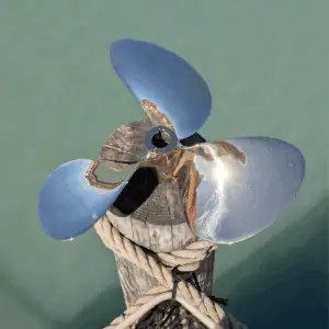 13 Inch Brass Propeller on Wood Post by Water