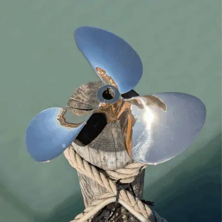 13 Inch Brass Propeller on Wood Post by Water