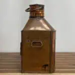 Side view of vintage copper ship lantern showing brass handle and burn marks