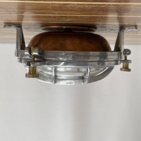 Vintage Aluminum Bulkhead Light with Copper Base and Brass Hardware Vintage aluminum bulkhead light mounted to ceiling with brass knobs visible