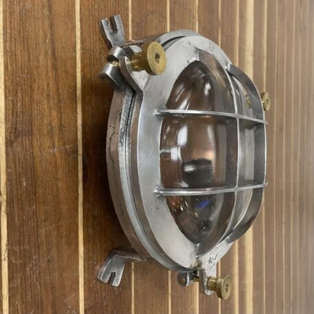 Vintage Aluminum Bulkhead Light with Copper Base and Brass Hardware Side wall-mounted view of vintage aluminum bulkhead light with glass and aluminum detail