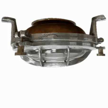 Close-up of copper and aluminum marine light with visible mounting brackets