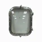 Close-up of salvaged four dog aluminum porthole standing upright