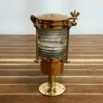 Close-up of small brass ship light with aged patina