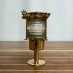 Side view showing brass body and clear Fresnel lens