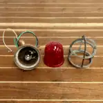 light disassembled to show red globe and wiring