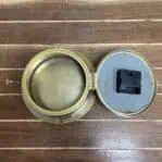Back view of vintage brass ship clock with battery-operated movement
