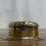 Side profile of vintage brass ship clock with brass body and locking knob