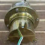 Salvaged brass ceiling light wiring detail and mounting legs