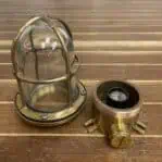 Salvaged brass ceiling light disassembled showing interior socket