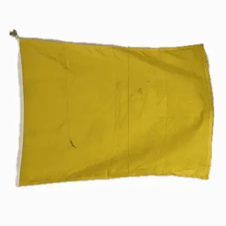 horizontal yellow nautical signal flag with signs of previous use