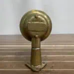 Rear view of short arm weathered brass wall sconce with patina
