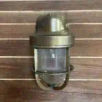 Front view of ribbed globe wall sconce with worn paint