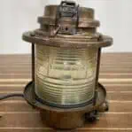 Side view of vintage ship lantern with clear lens and wear