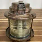 Close-up of brass marine lantern showing latch and lens texture