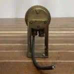 Rear view of brass fixture showing conduit wiring