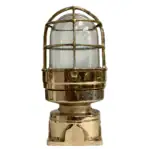 Brass nautical fixture with clear glass globe and protective cage