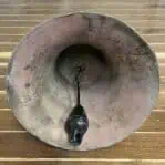 Salvaged brass ship bell underside detail showing wear and surface texture