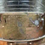 Close-up of label on brass navigation lights showing flasher instructions