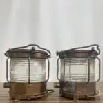 Side profile of salvaged brass navigation lights with clear fresnel lens