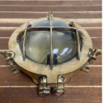 vintage brass cage light front view with cracked glass globe