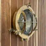 vintage brass cage light wall mounted side angle with cracked glass