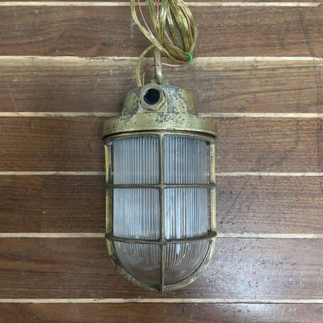 Vintage Brass Ceiling Light with Chain and Ribbed Glass Globe - Weathered 03 Vintage Brass Ceiling Light with Ribbed Glass Globe front detail on wood surface
