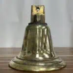 Weathered brass ship bell front view showing etching and surface wear