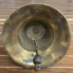 Interior of weathered brass ship bell showing patina and metal wear