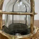 Close-up of glass dome showing wear on brass and aluminum marine post light